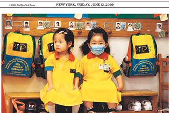 Image of the NY Times' cover, which mentions how the WHO has declared the swine flu a pandemic; these are youngsters in Hong Kong, where swine flu worries have shut down schools.